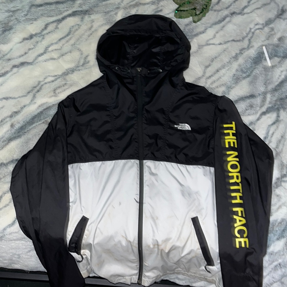 The North Face windbreaker large black and white with yellow branding